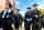 Four graduates smiling at commencement