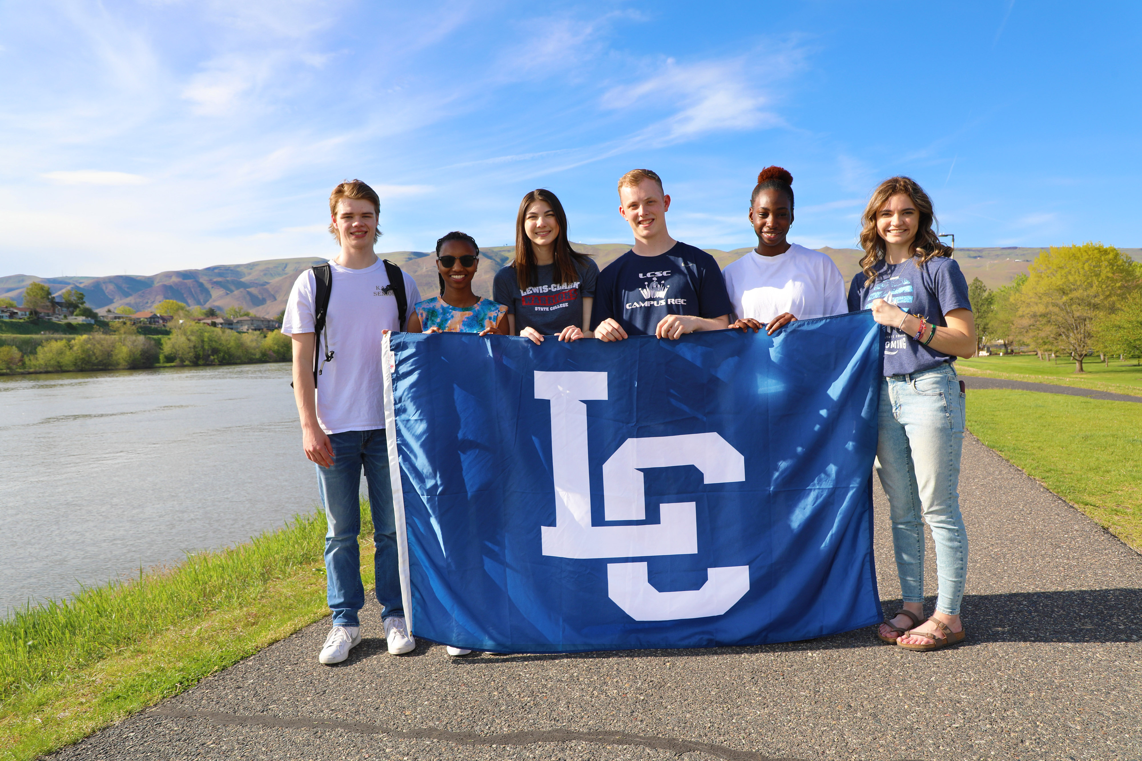 Students holding campus flag