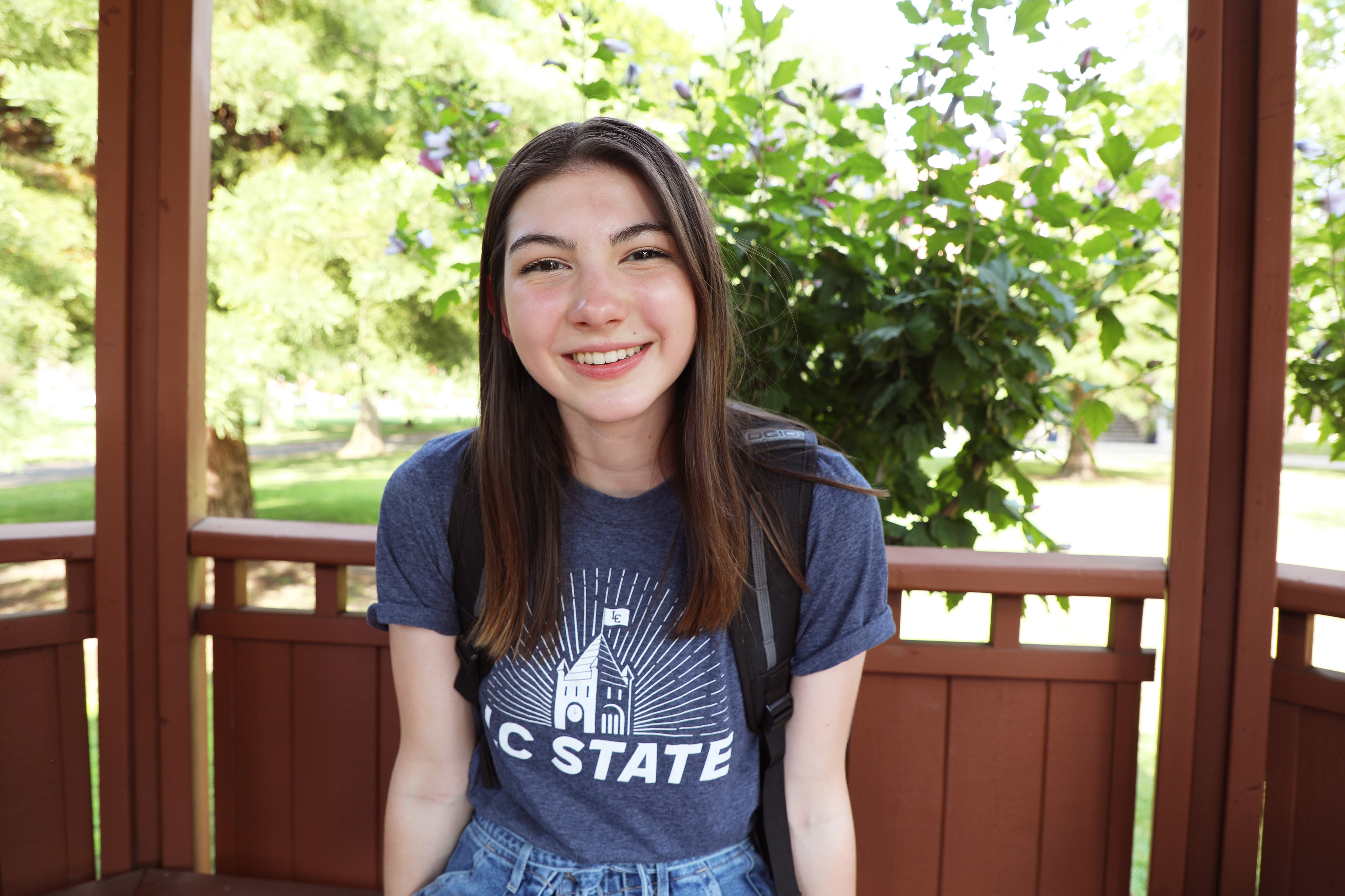 Student sitting outside in a gazebo