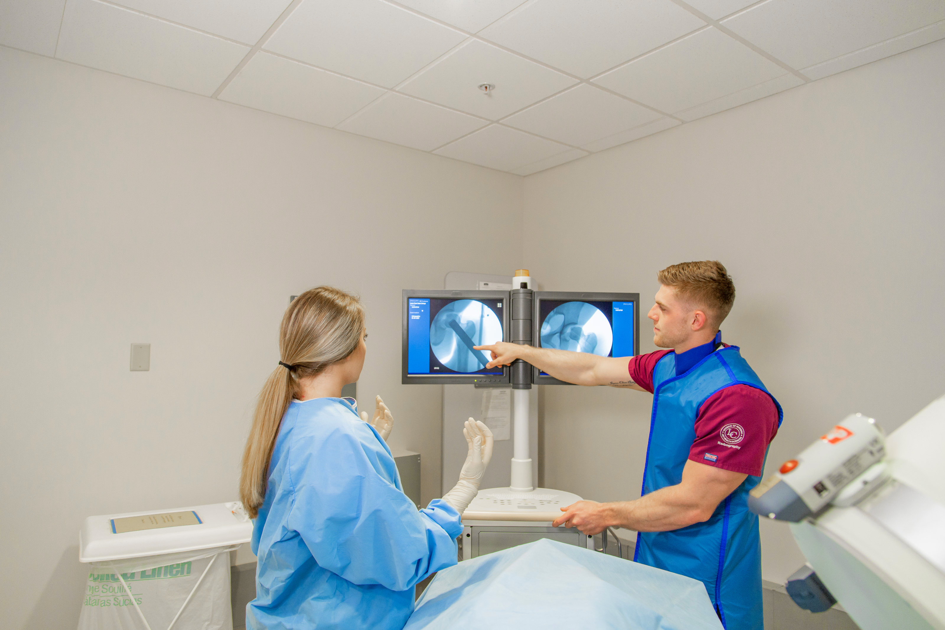 Two students looking at scans on a monitor
