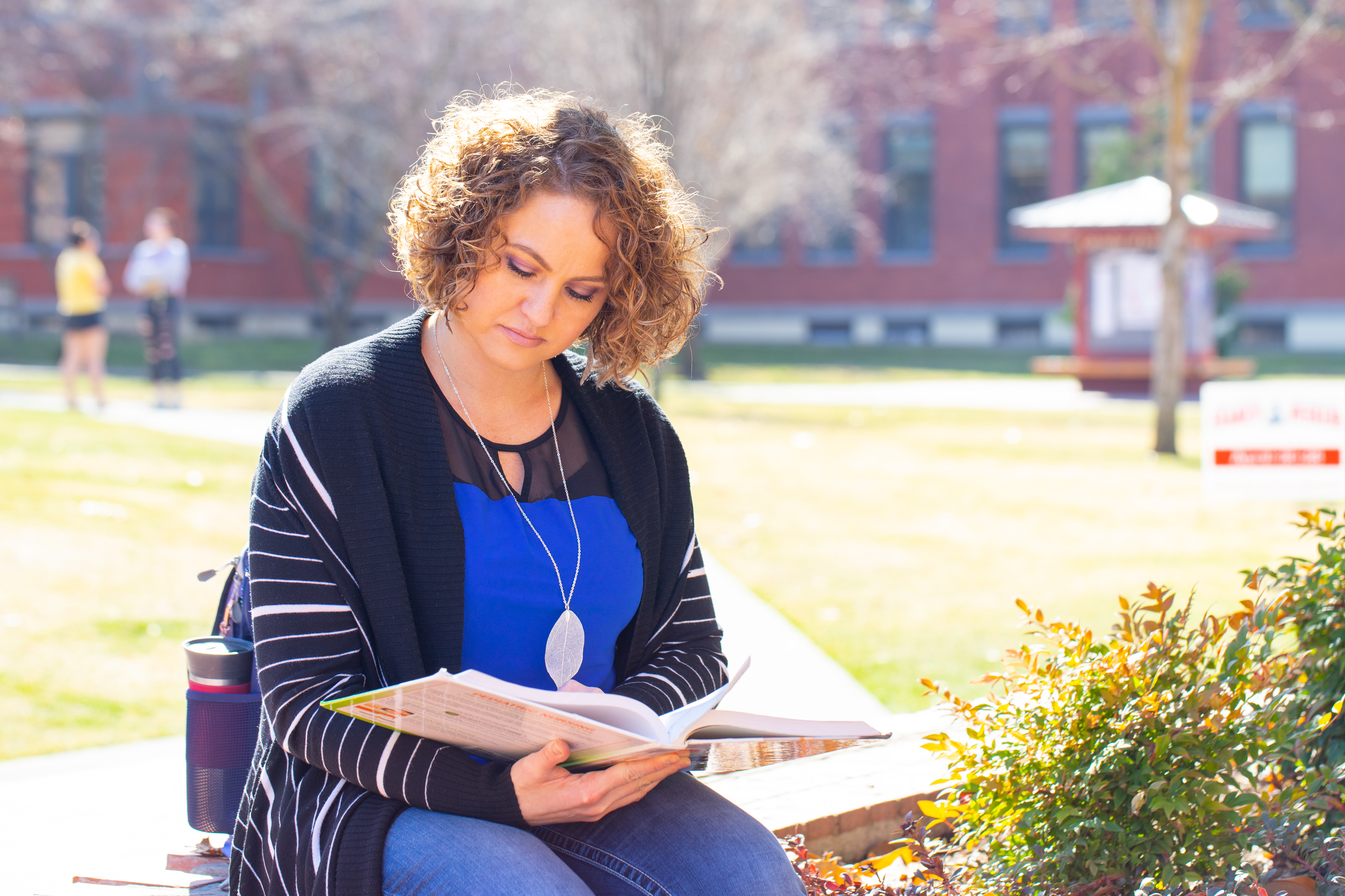 Student studying outside on campus.