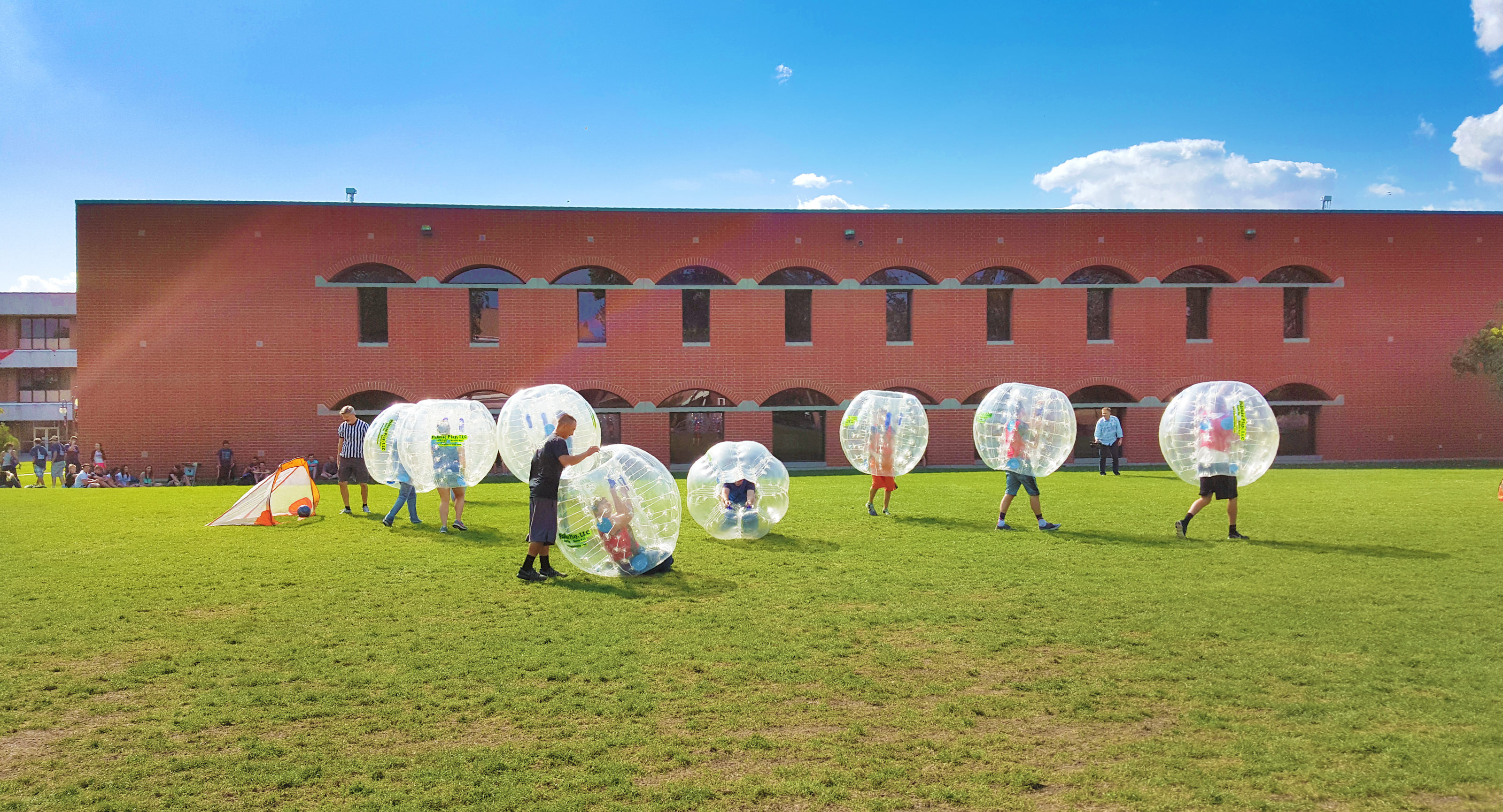 Students playing games on campus lawn