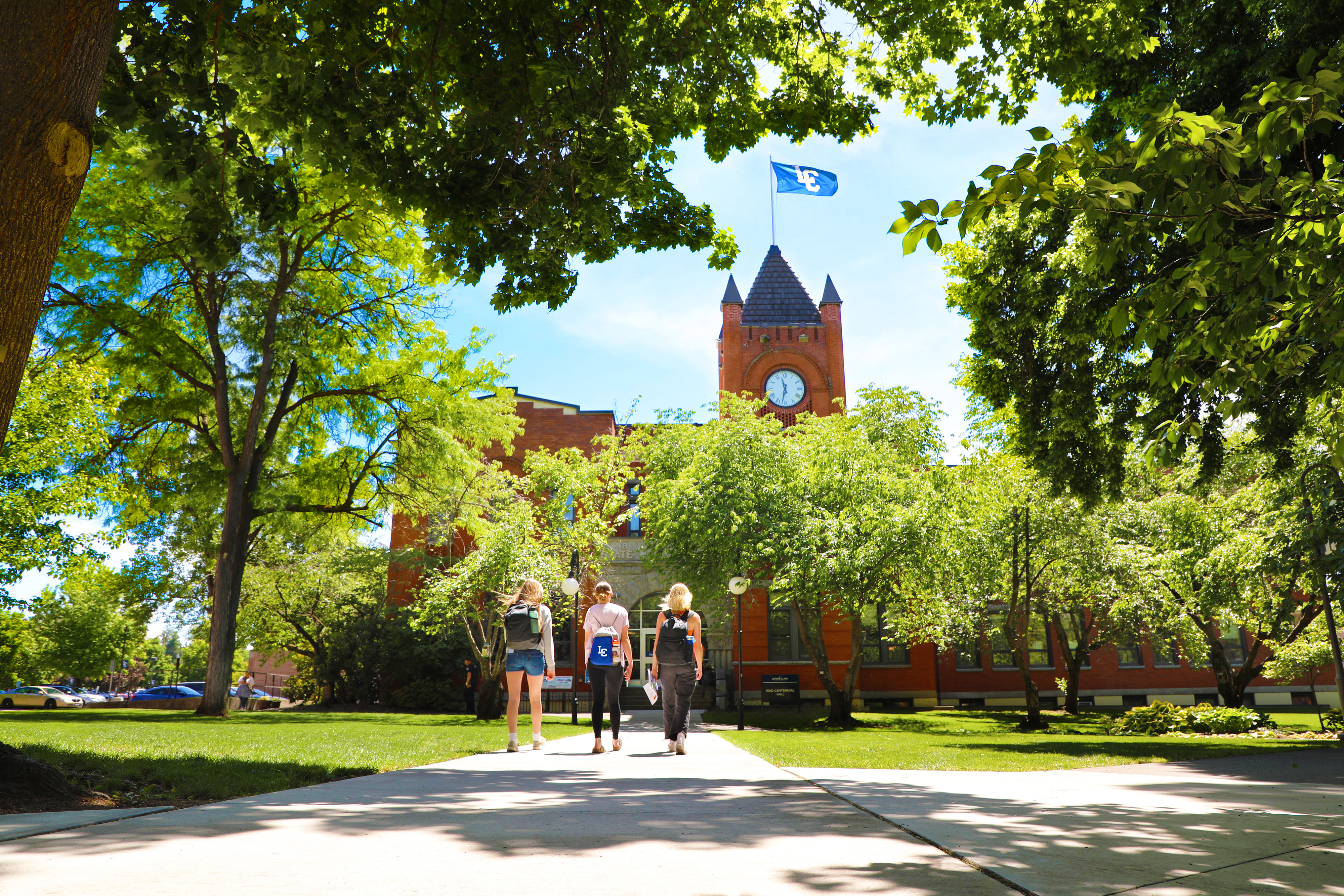 Three LC State Students walking toward Reid Centennial Hall