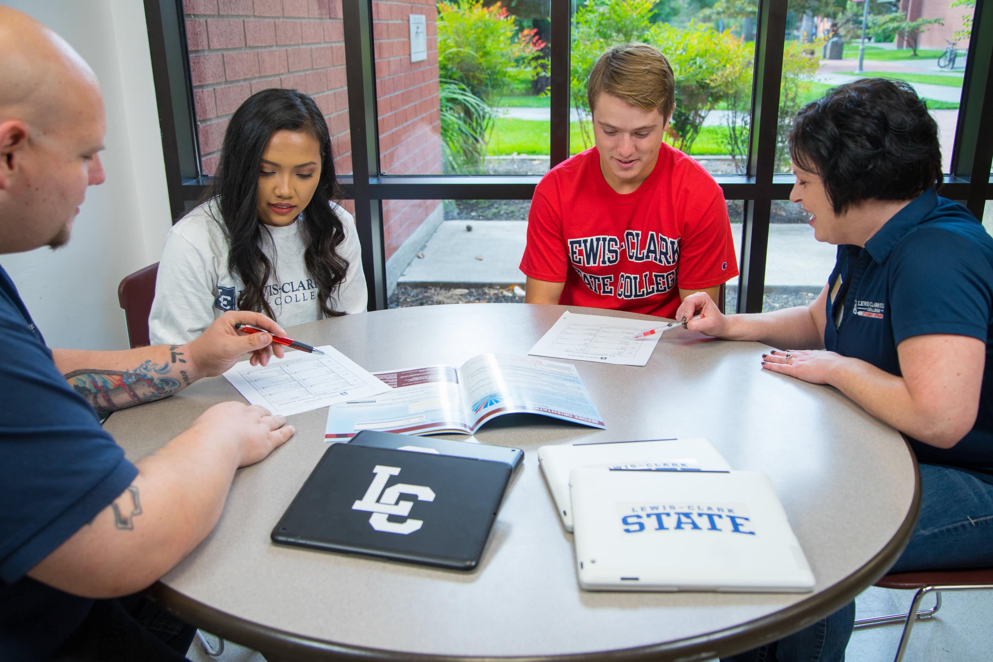 Students and advisors working at a table