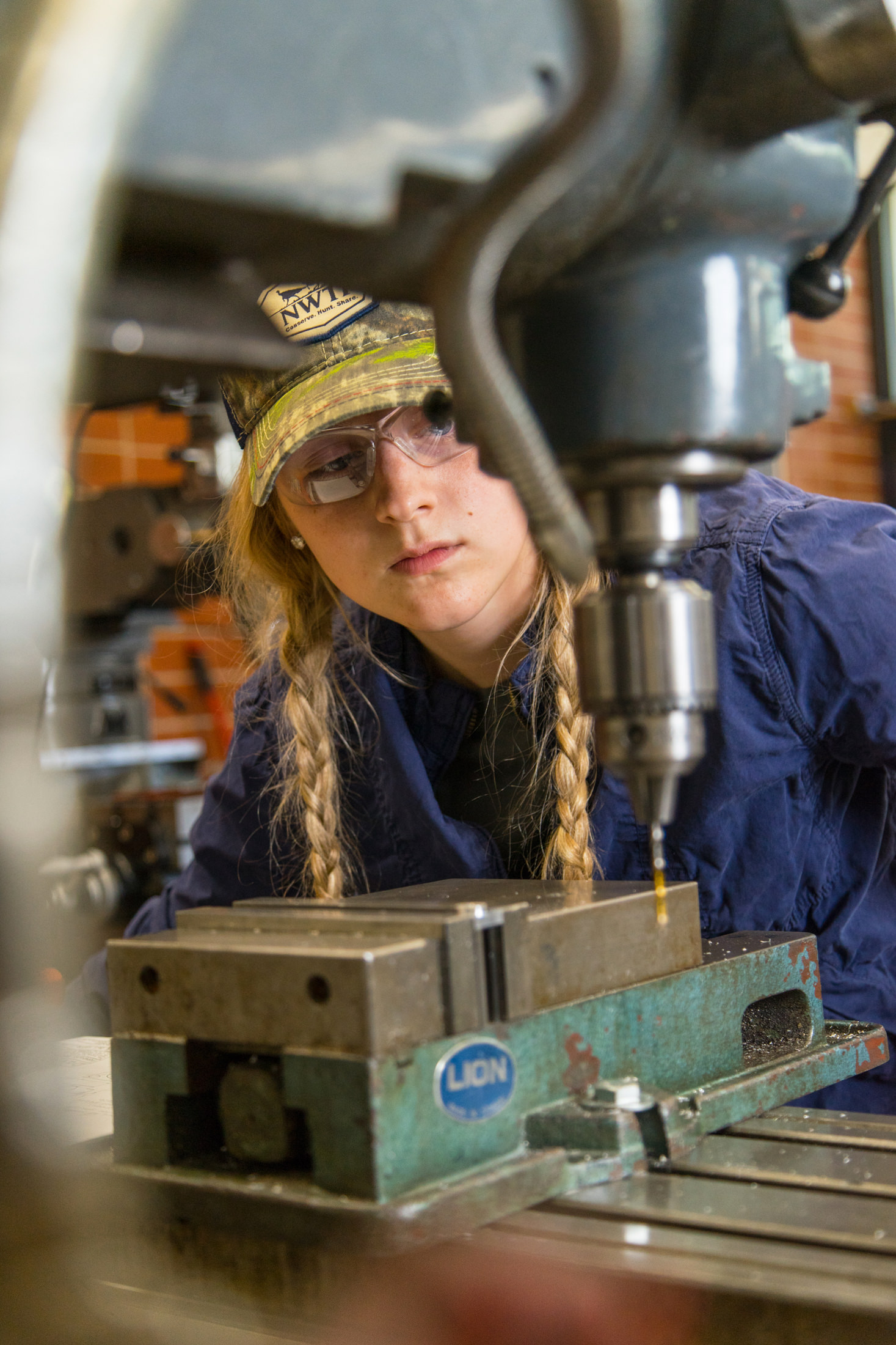 Student using a drill press