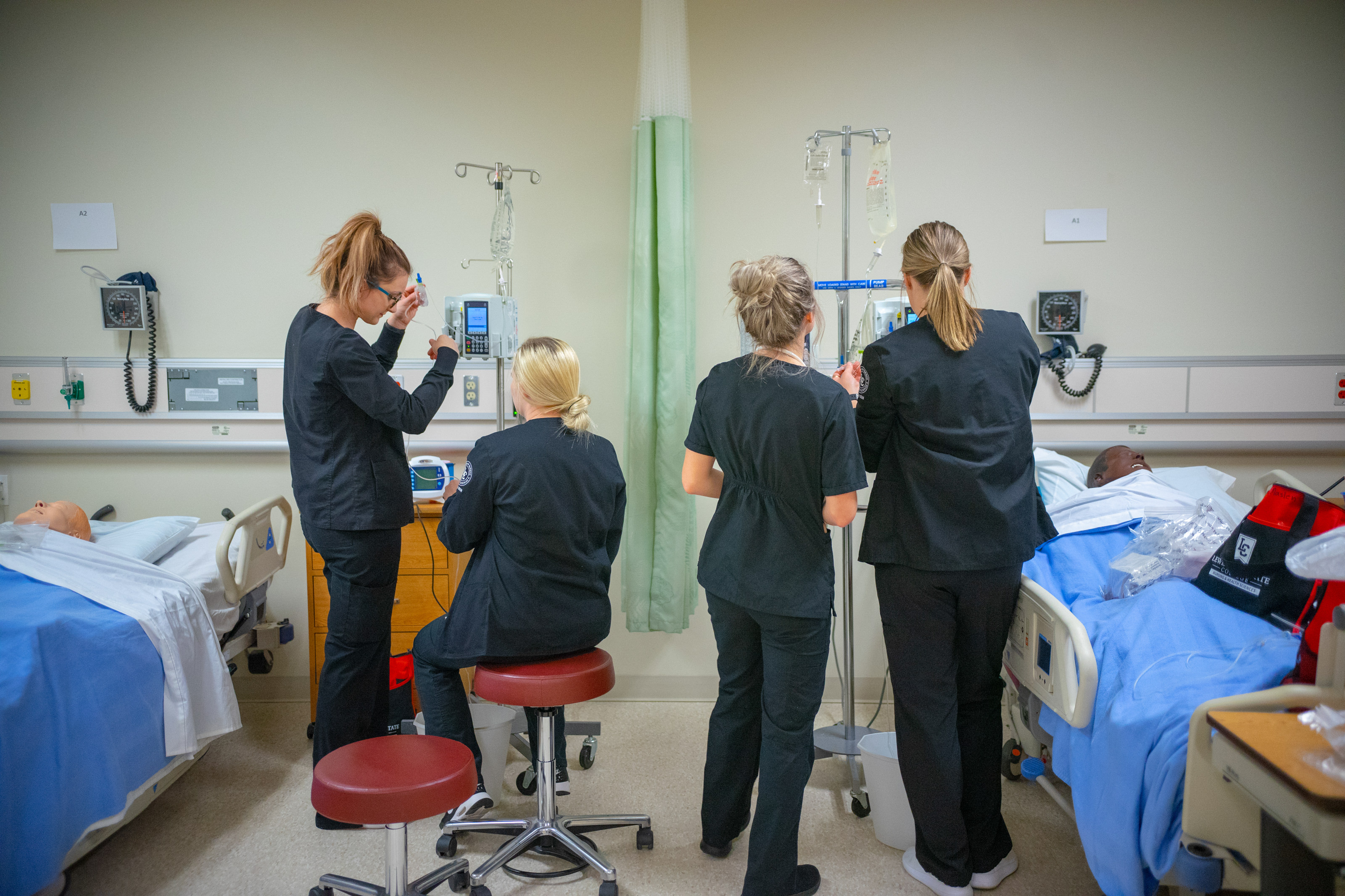 Four nurses in training lab