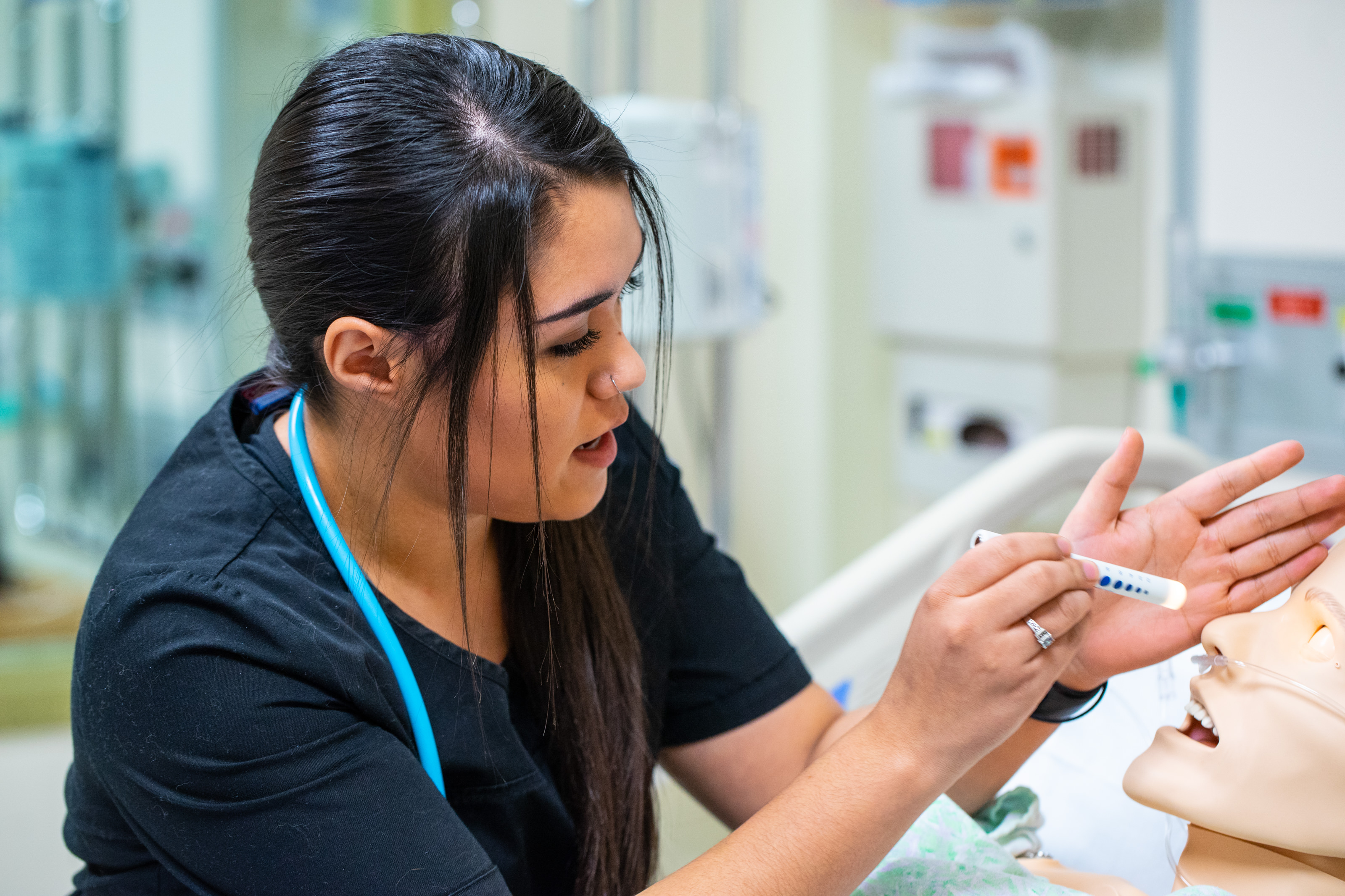 Student in medical simulation lab.