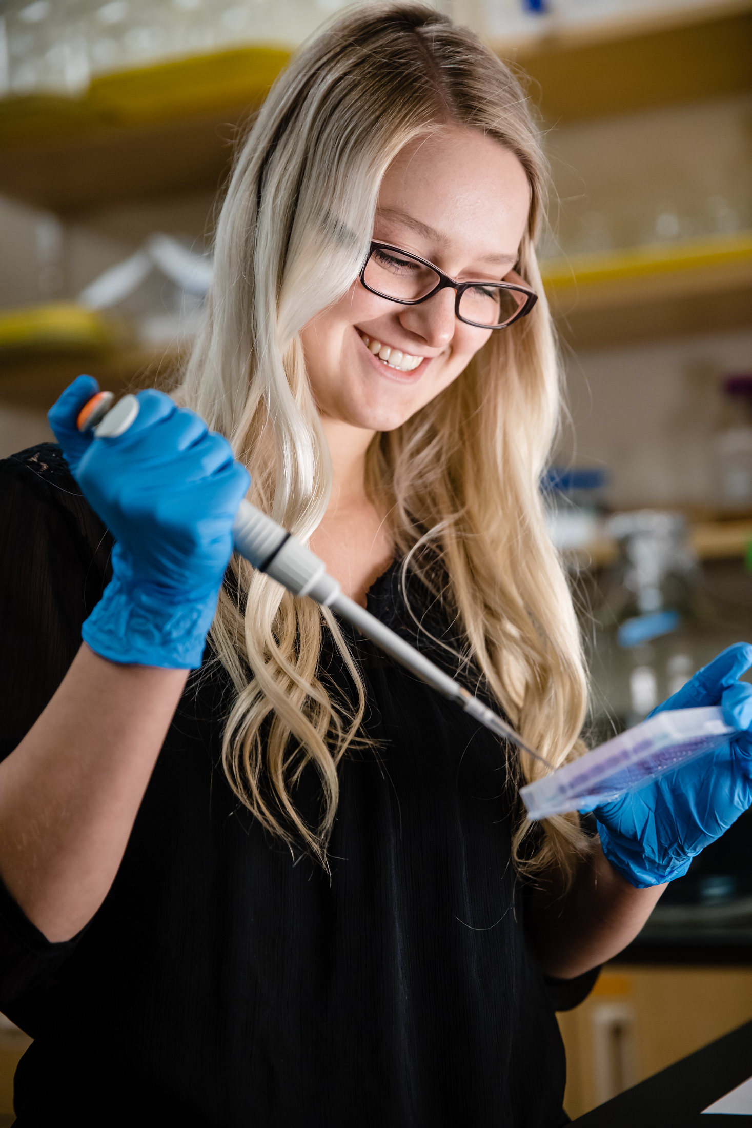 a student pipetting