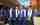 Five students at outdoor graduation ceremony