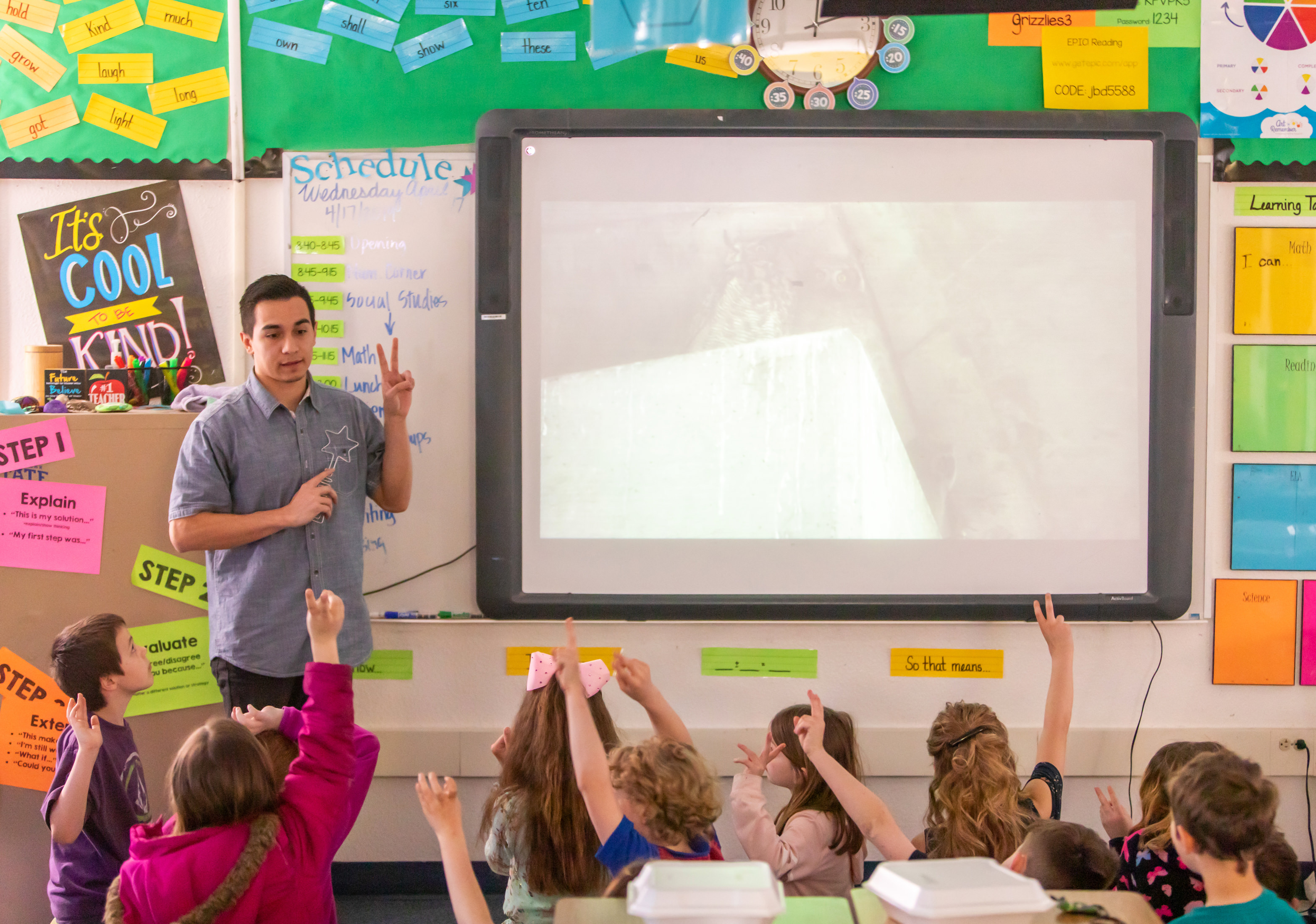 Male teaching teaching children in a classroom