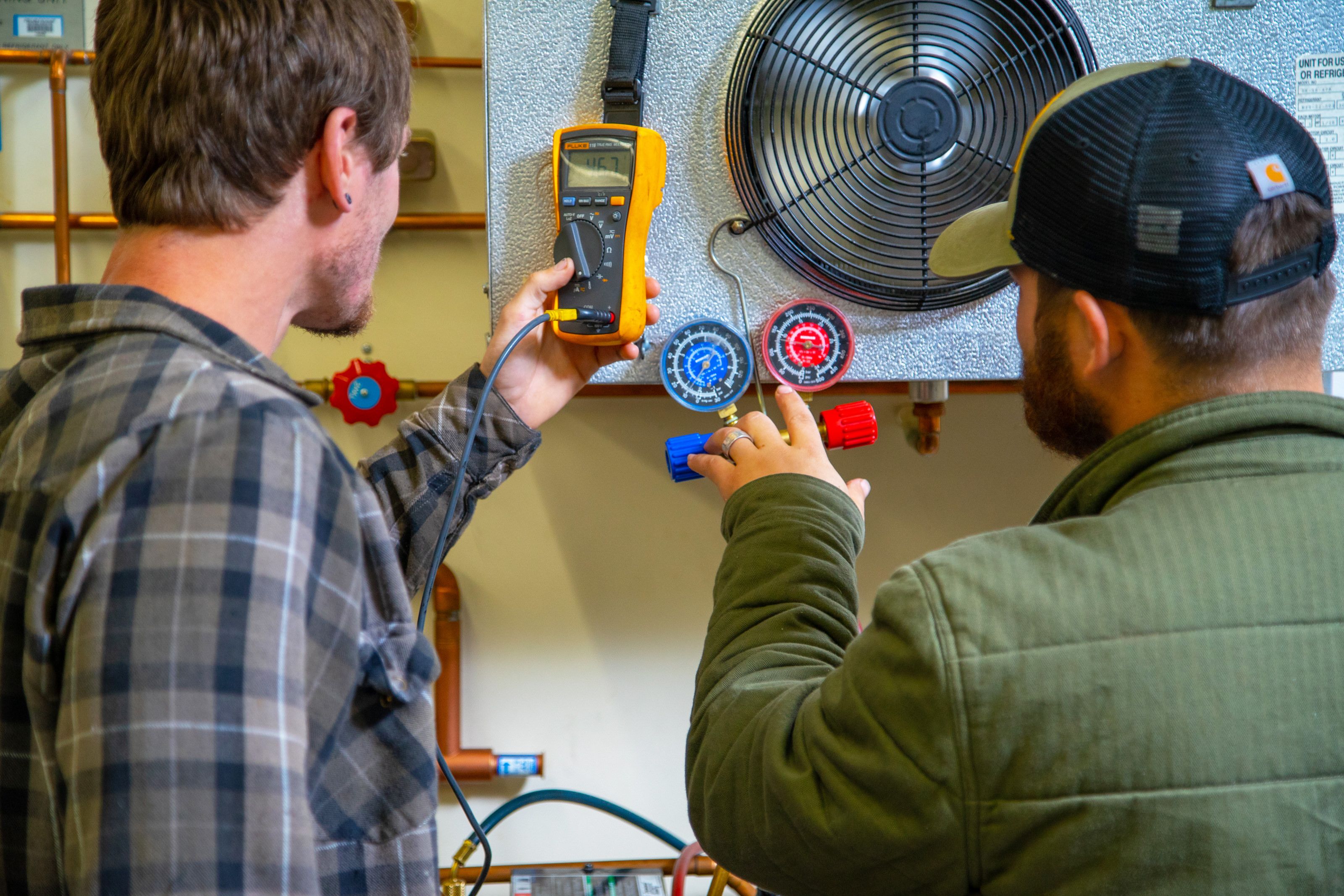 Two male students look at electronics