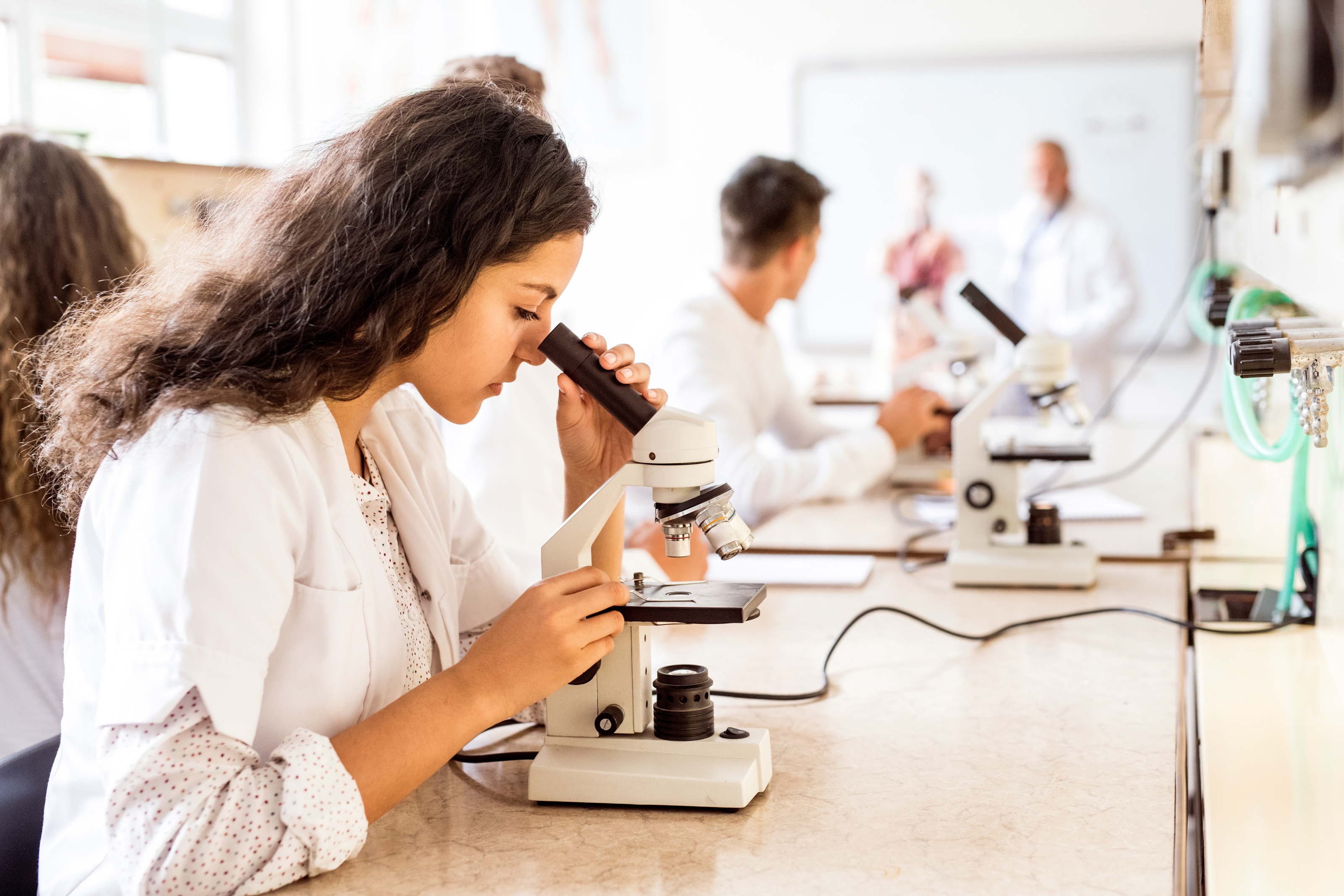 Female forensic scientist working in lab coat