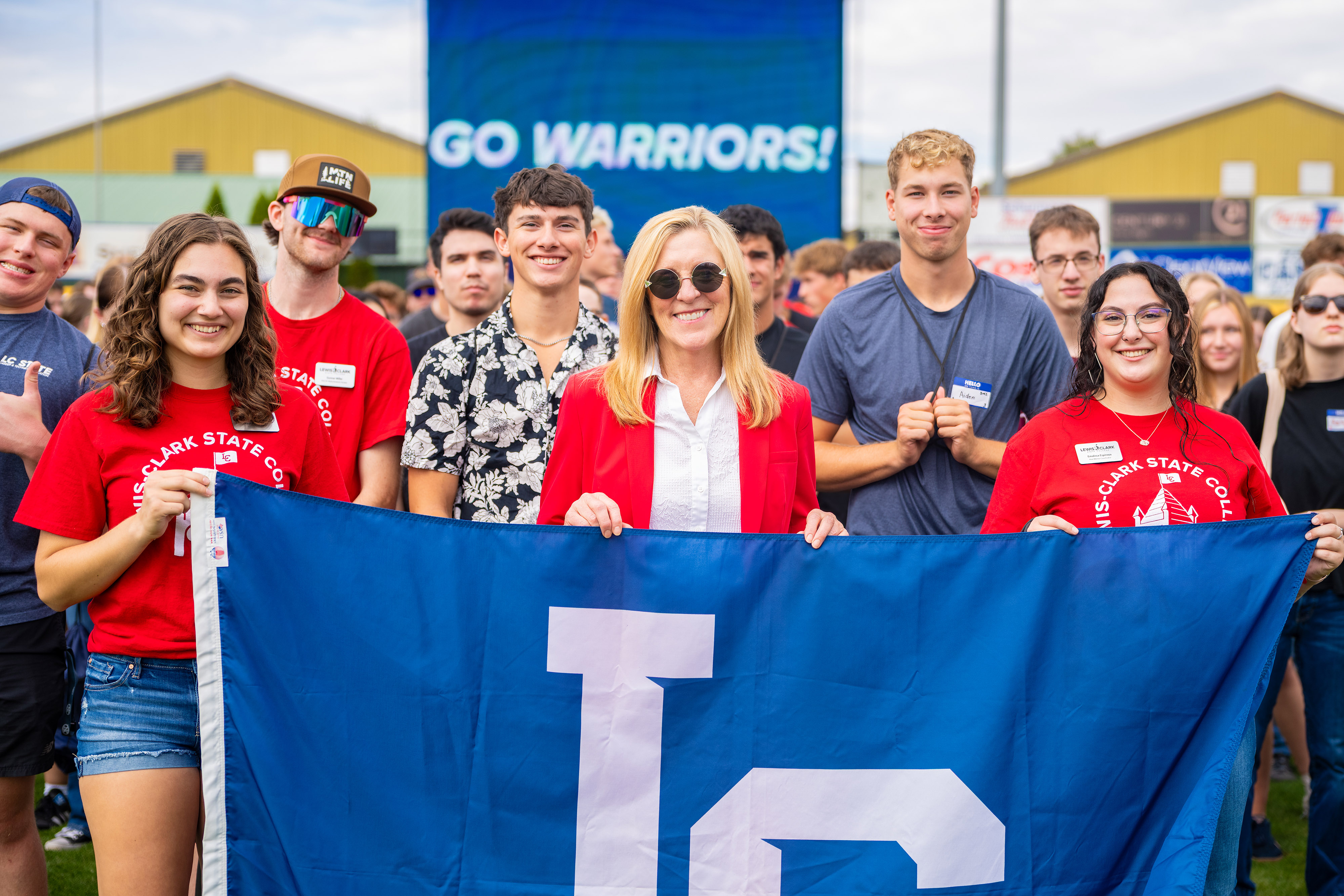 President Pemberton with students holding LC State flag
