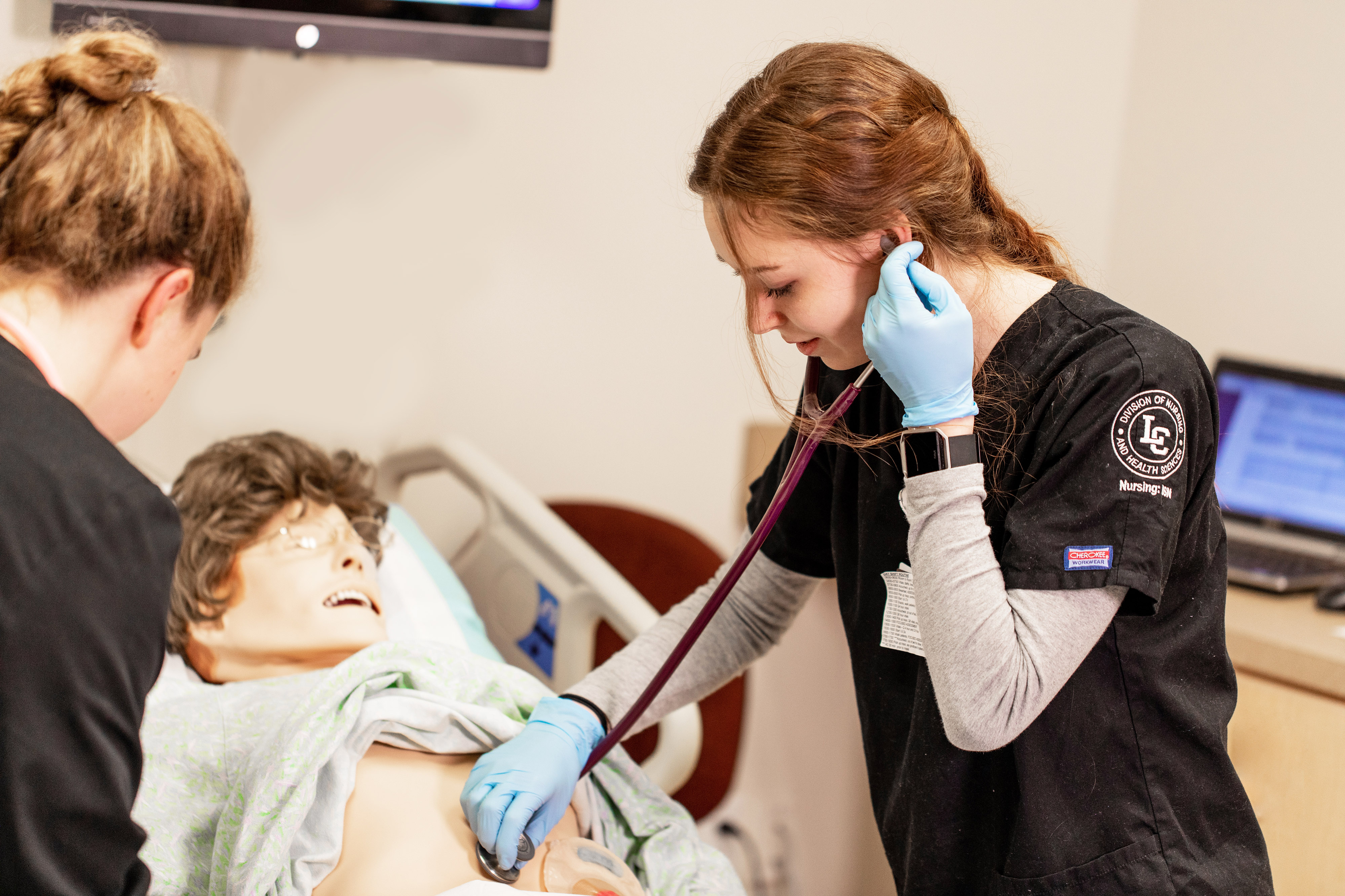 Nursing students working on a simulator manikin 