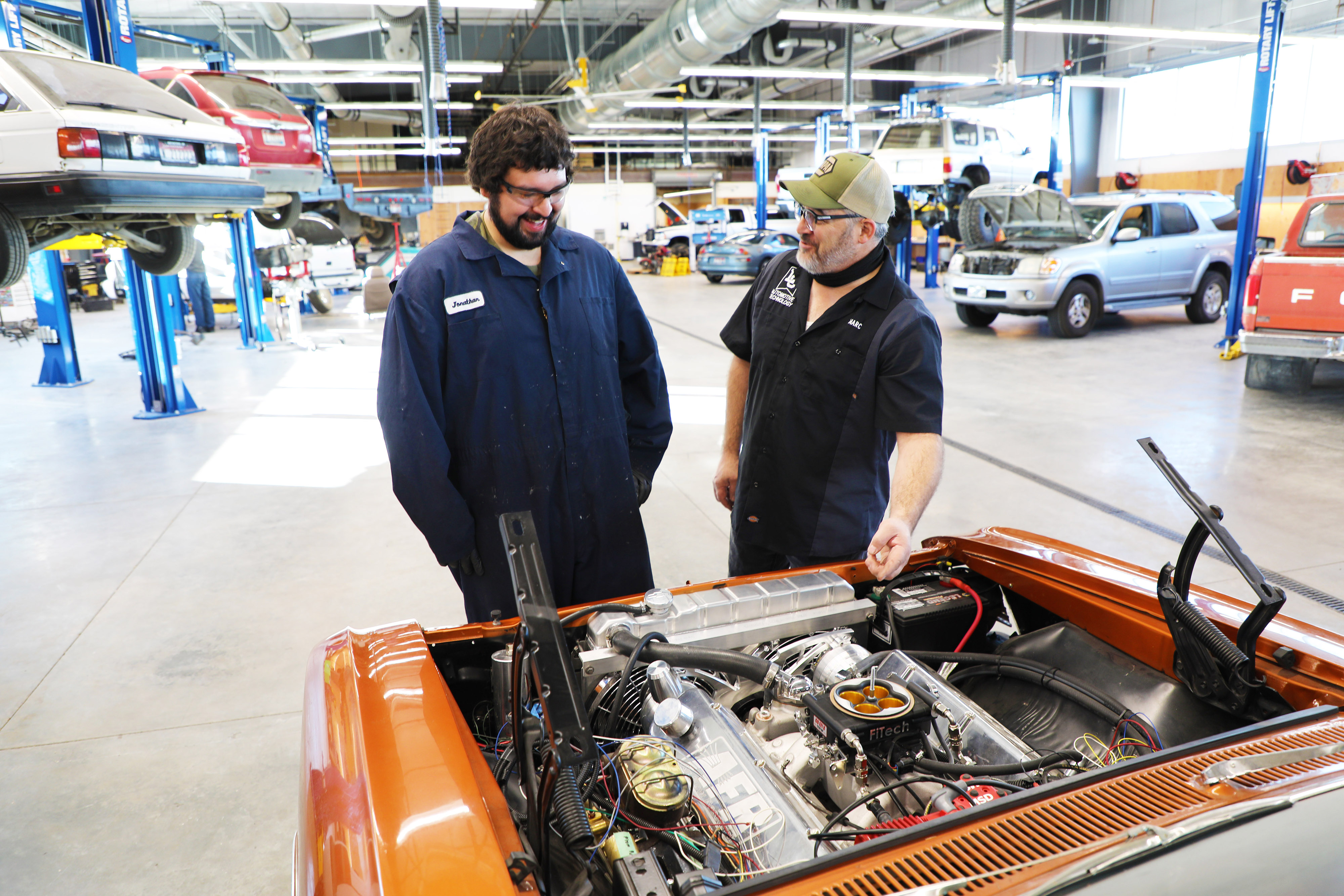 Two students working on a car