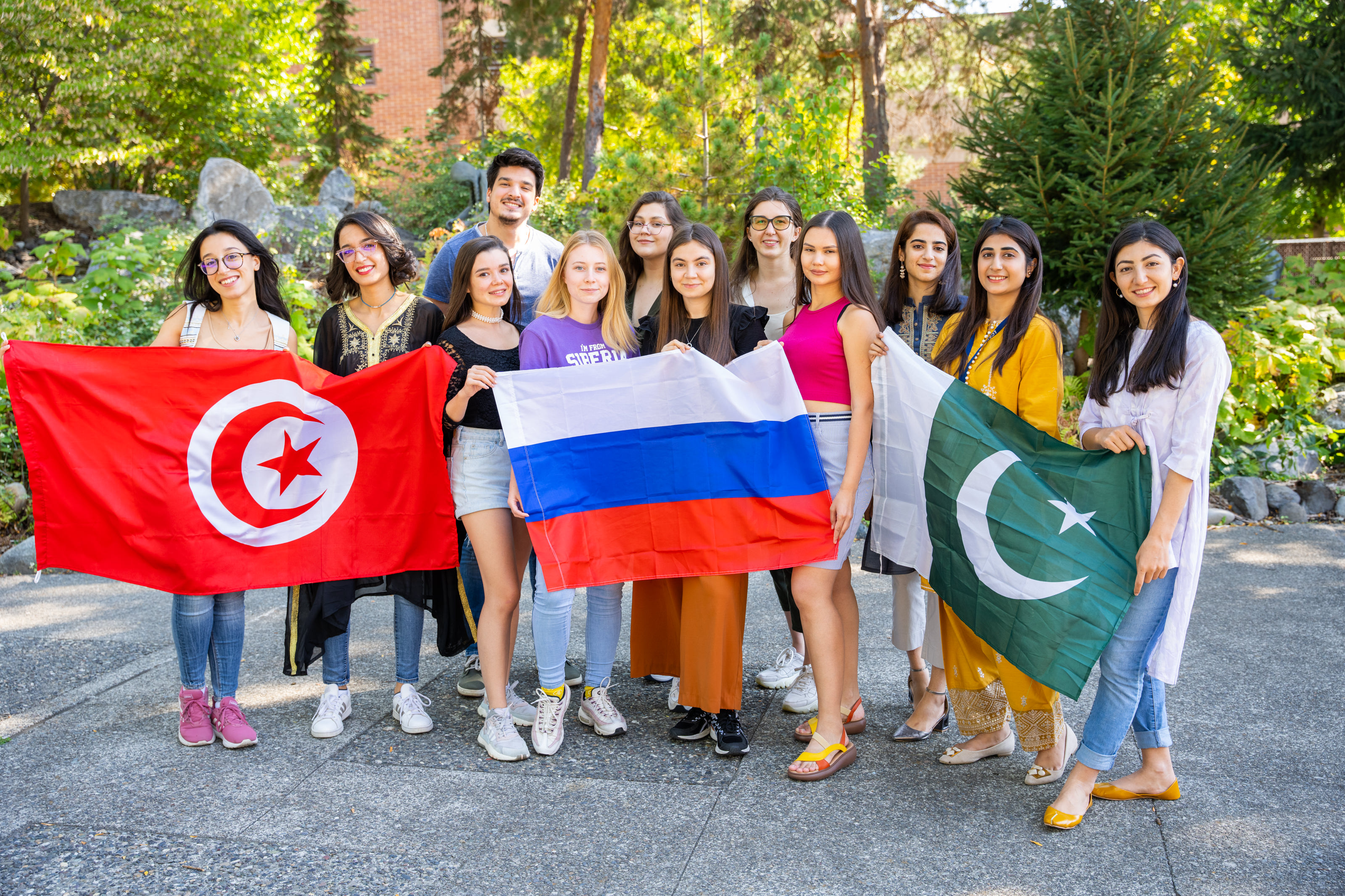 International students holding up flags from their home countries