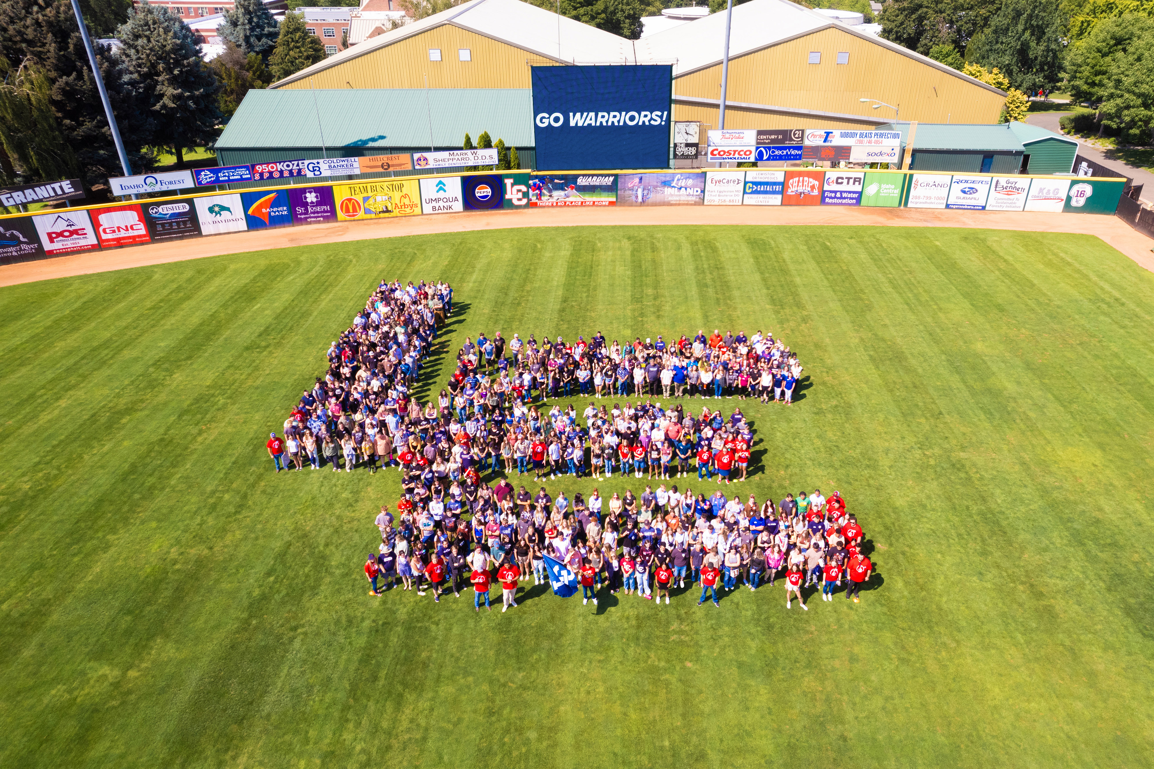 Hundreds of LC State students and faculty forming an interlocking LC at Harris Field