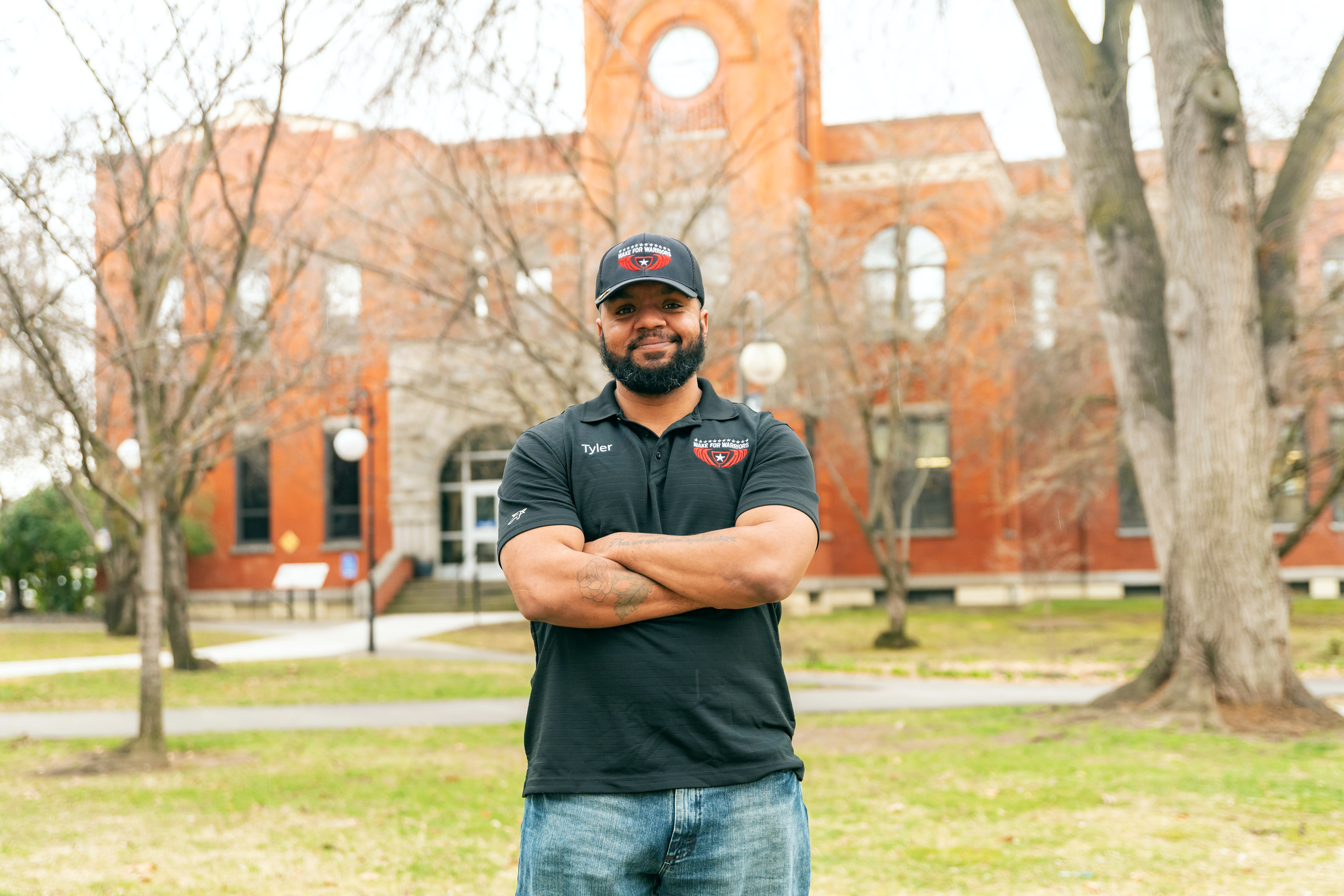 Work study member posed in front of LC State Reid Centennial Hall