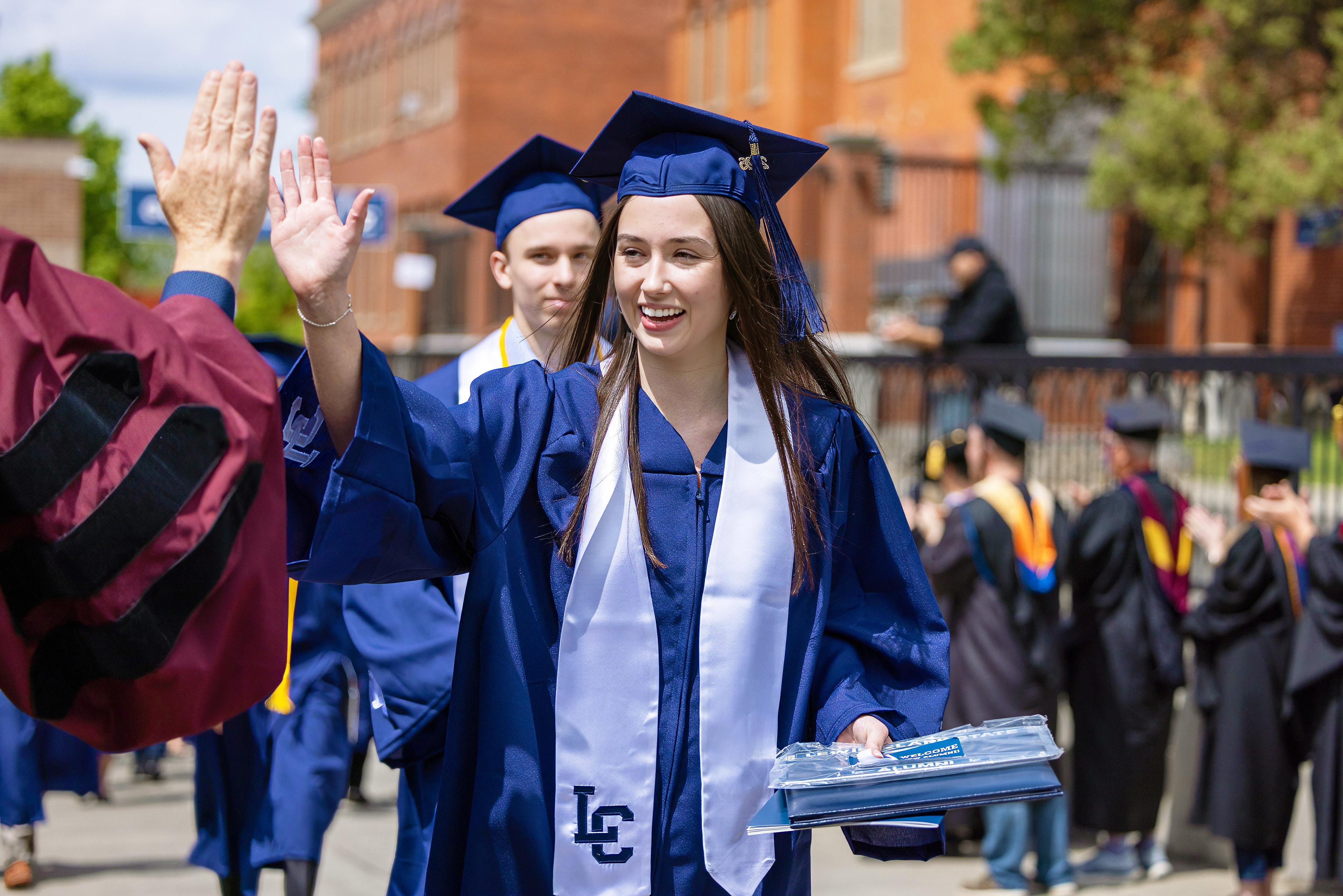 Graduates seated during commencement at Harris Field