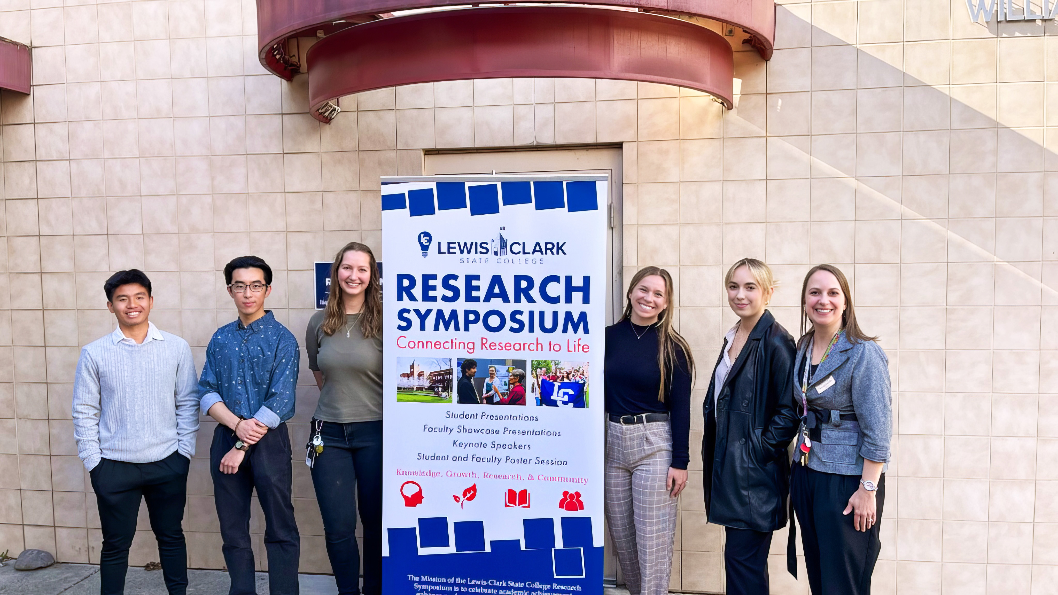 Lewis-Clark State College students pose are photographed with a Research Symposium sign