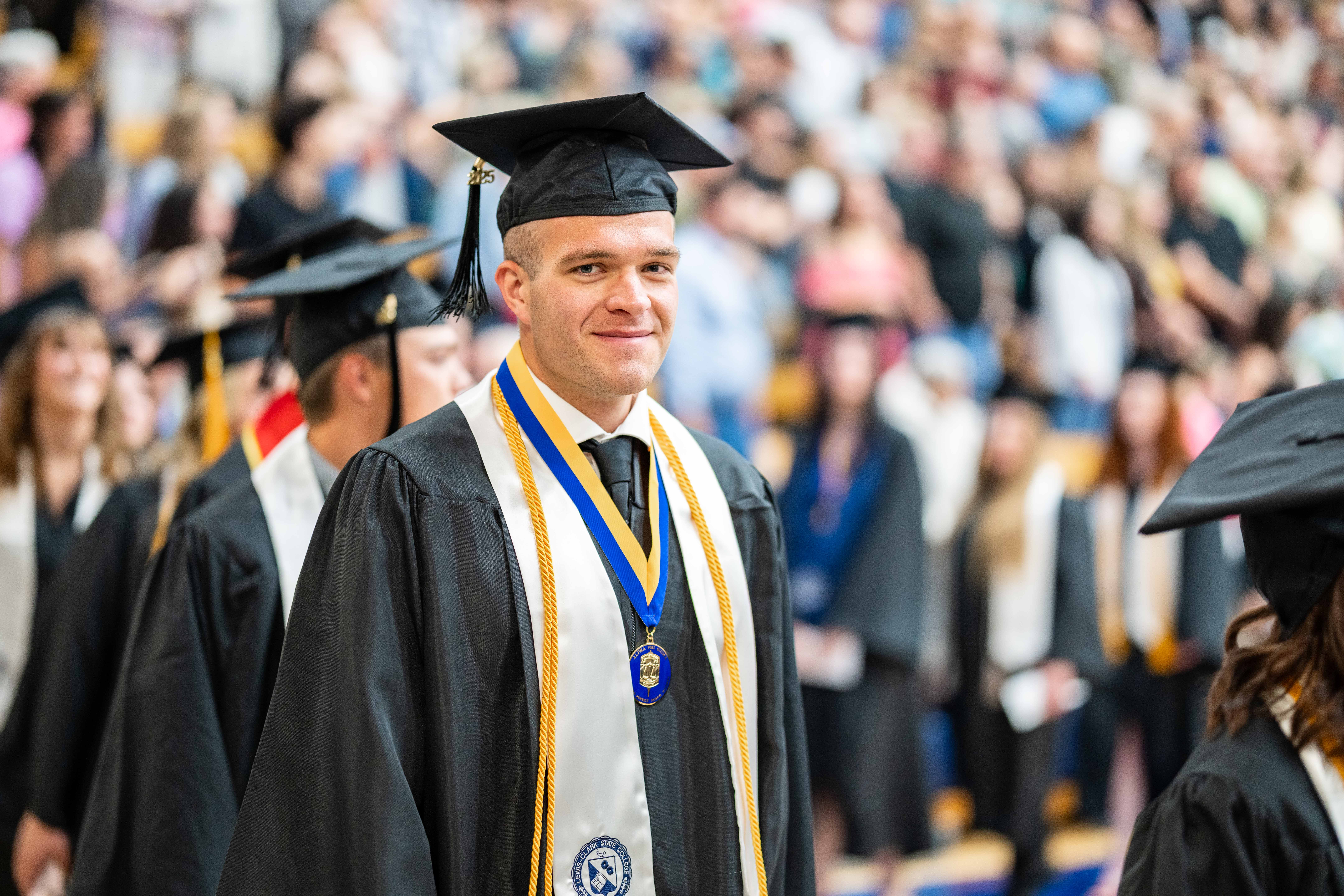 Student walking at commencement