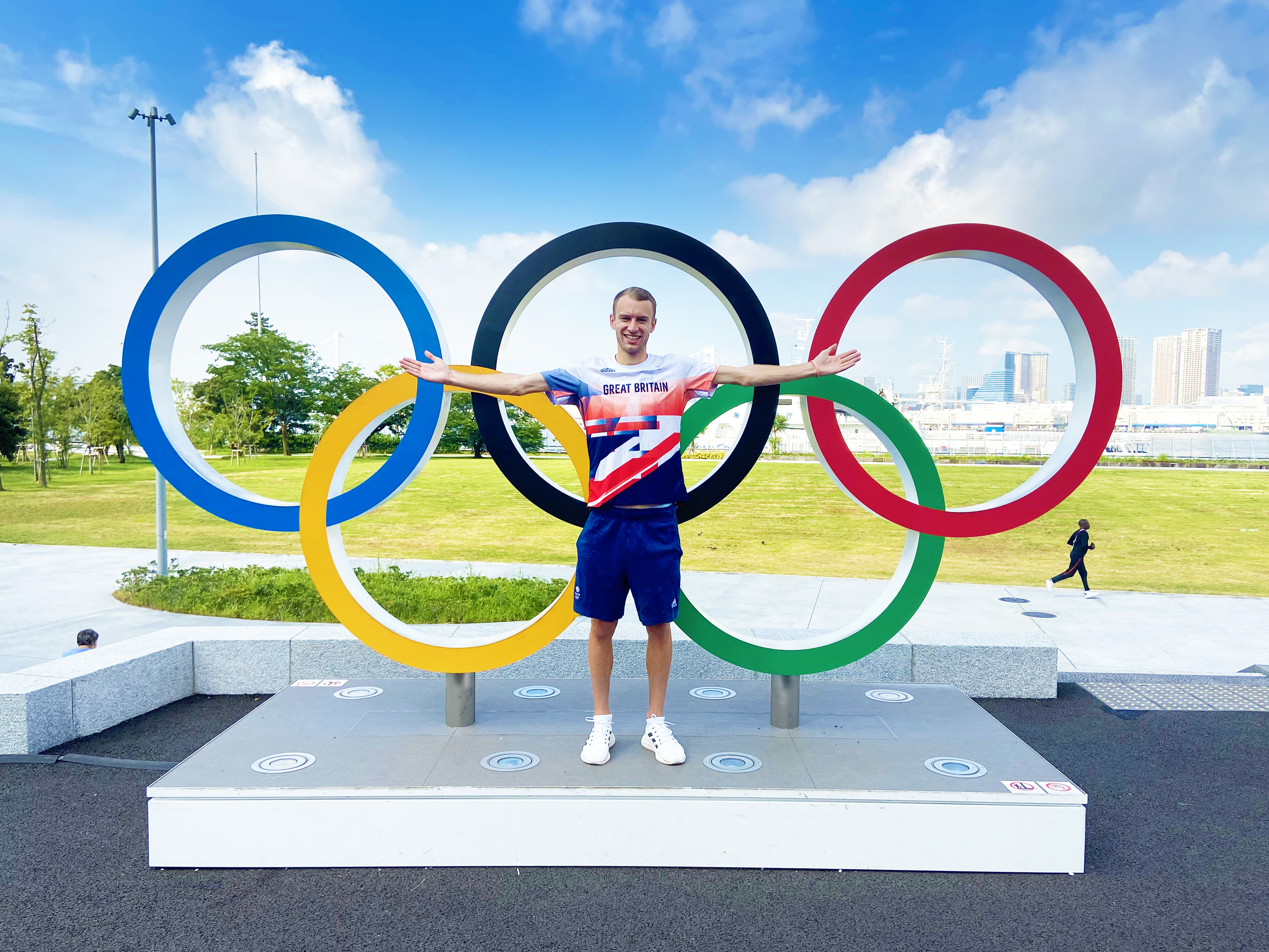 Olympian Sam Atkin posed in front of Olympic Rings