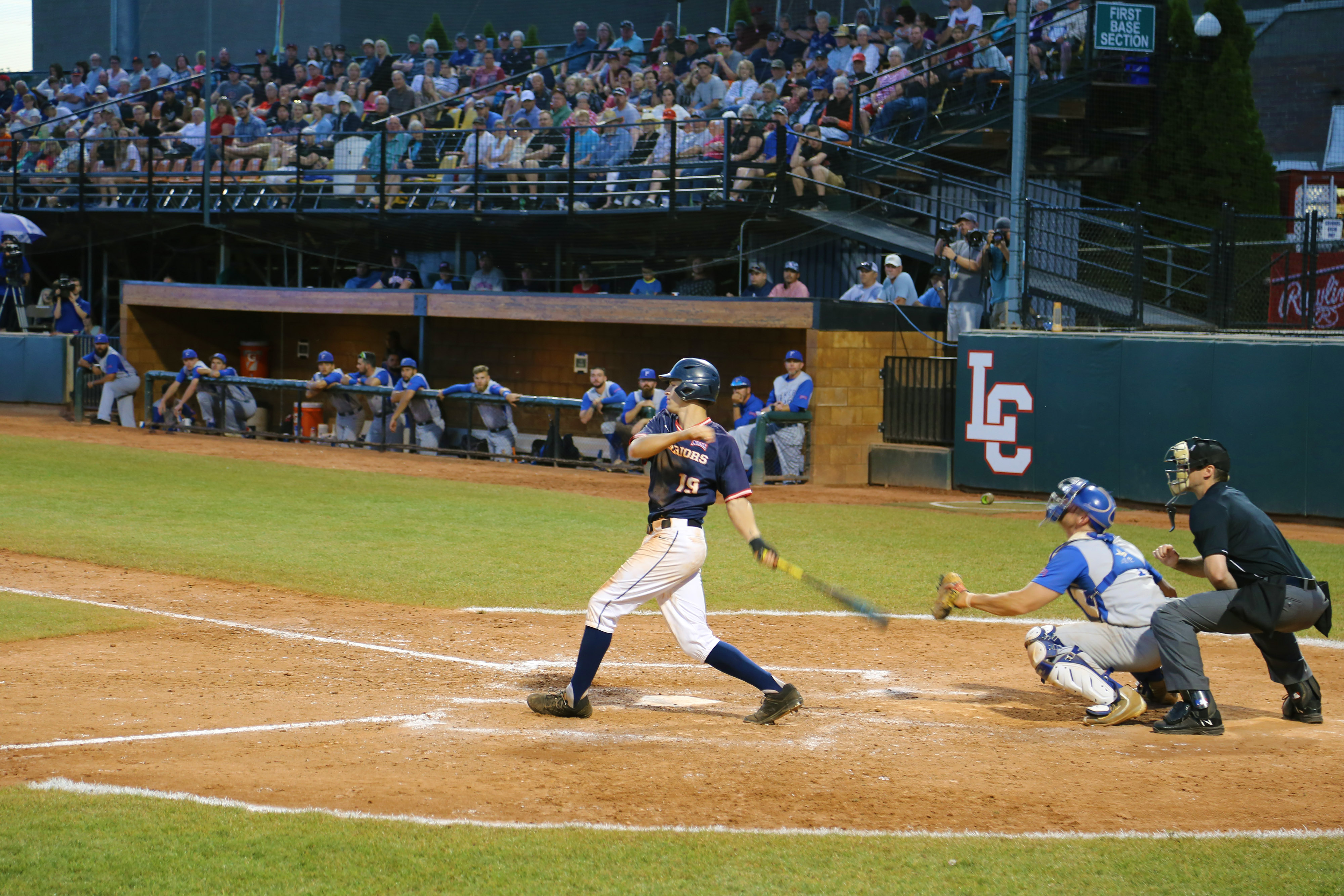 LC State Baseball Player Batting while stadium watches