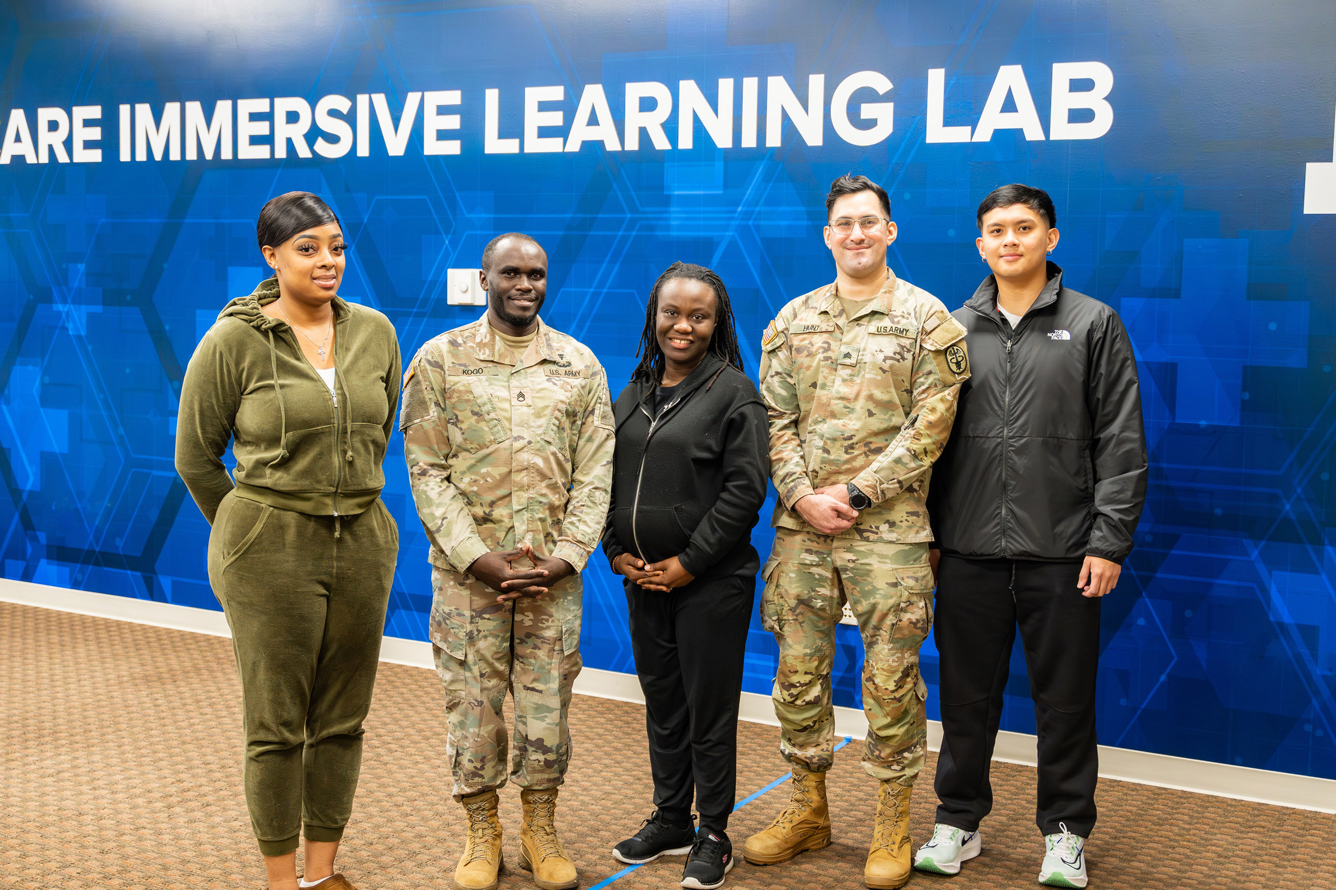 Five Active Duty LC State students in nursing program posed for photo in Healthcare Immersive Learning Lab