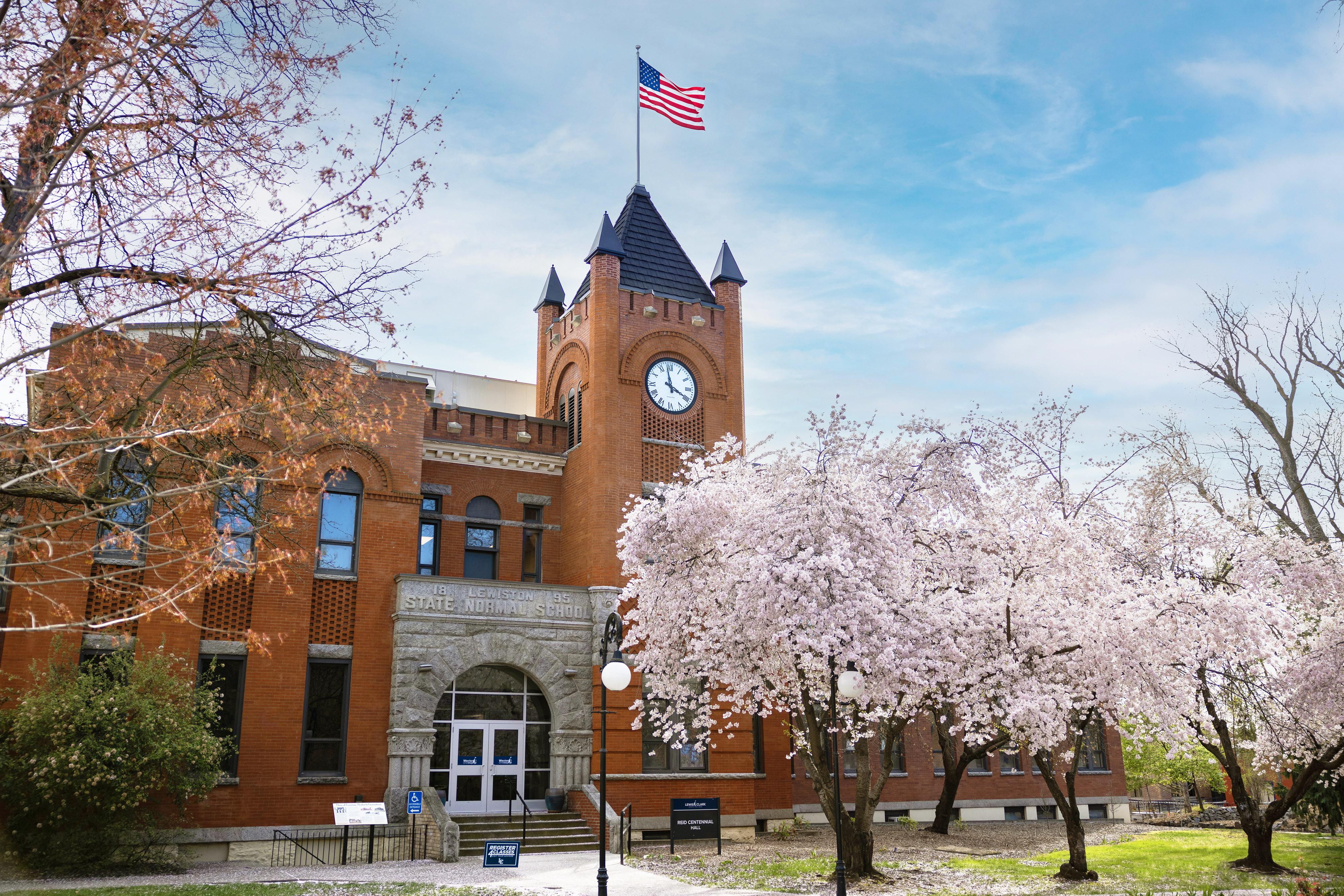 Reid Centennial Hall with spring cherry tree blossoms